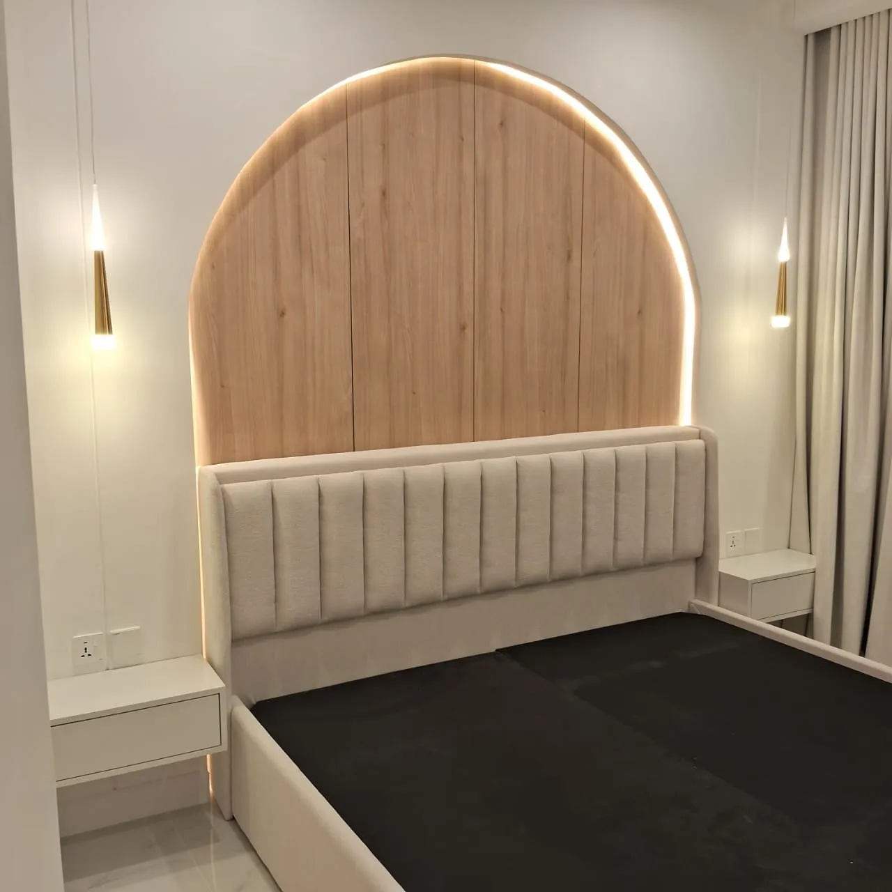 Arched oak headboard wall with an LED cove and a channel tufted bedhead