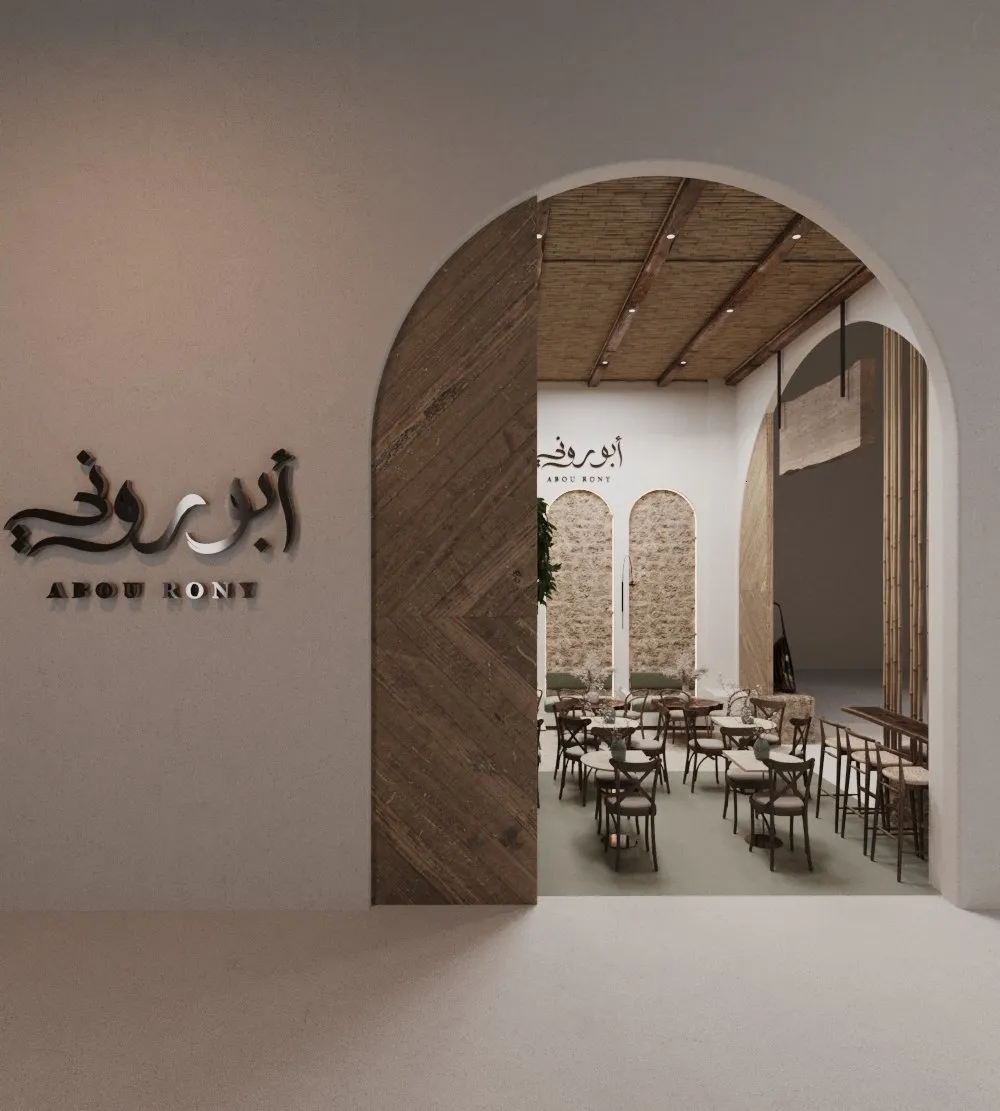 Entrance archway with wall mounted signage and seating visible beyond