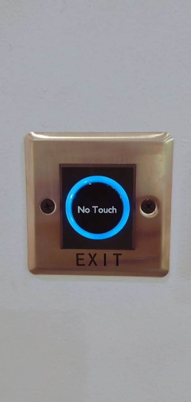 Contactless exit button in a brushed bronze faceplate