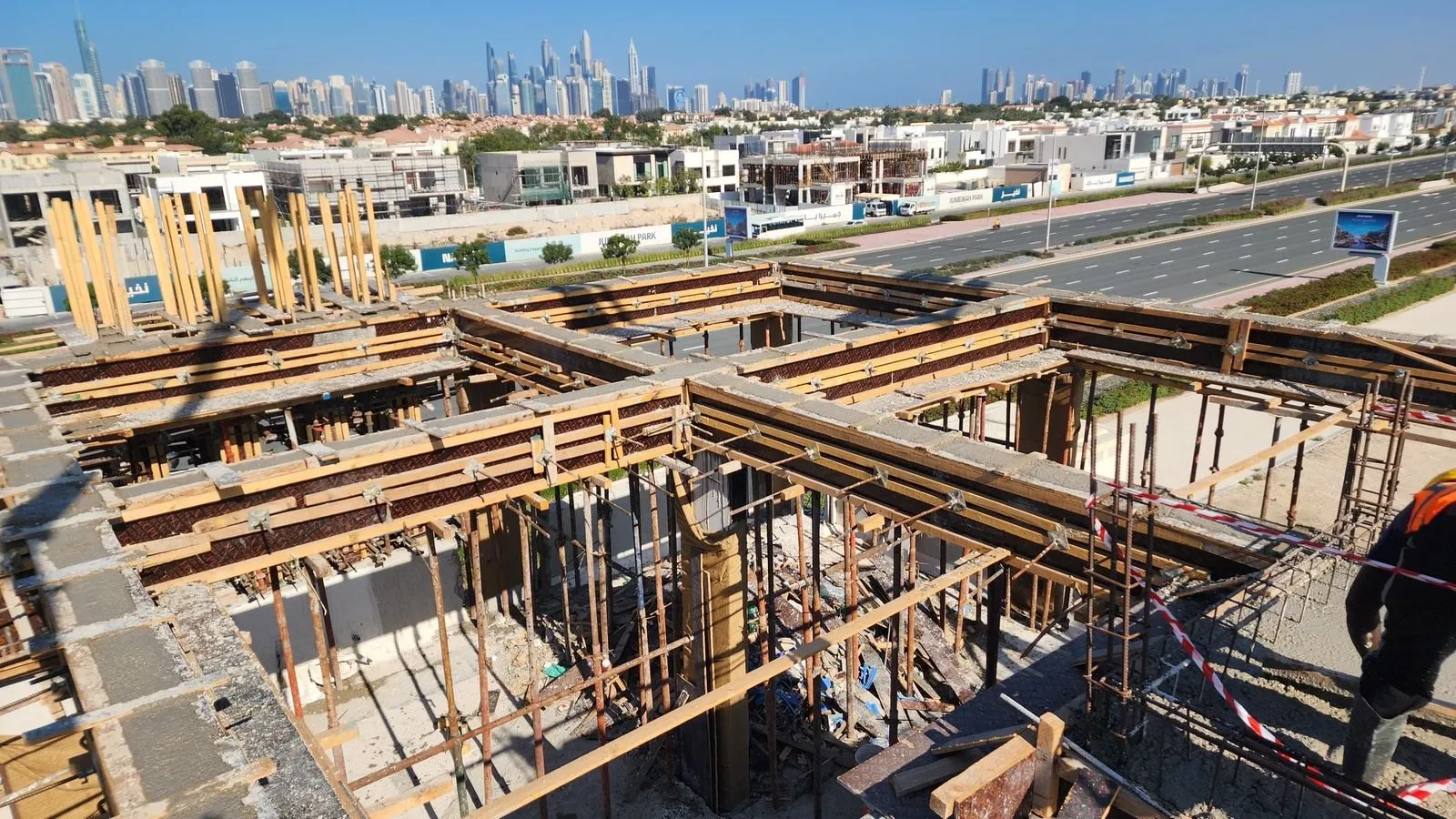 Beam and soffit formwork across a full floor plate with the skyline beyond