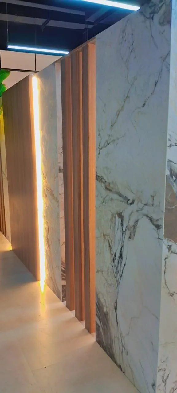 Corridor with a marble clad wall, oak fluting and a recessed light line