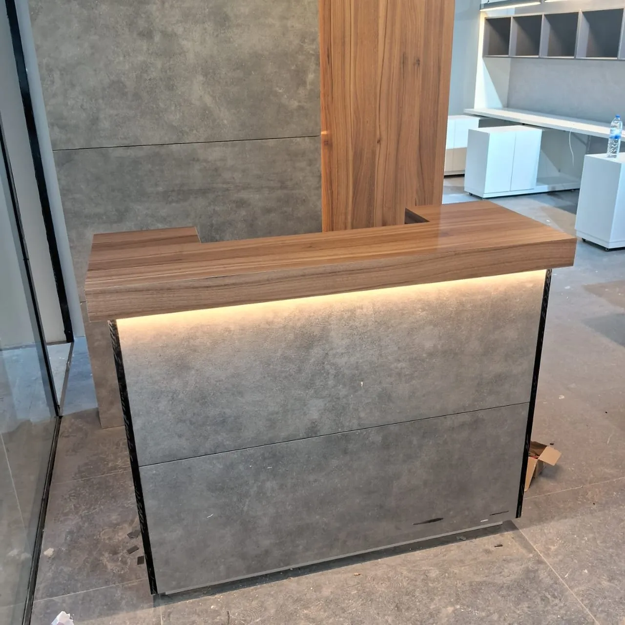 Reception desk part way through installation with site materials still in place
