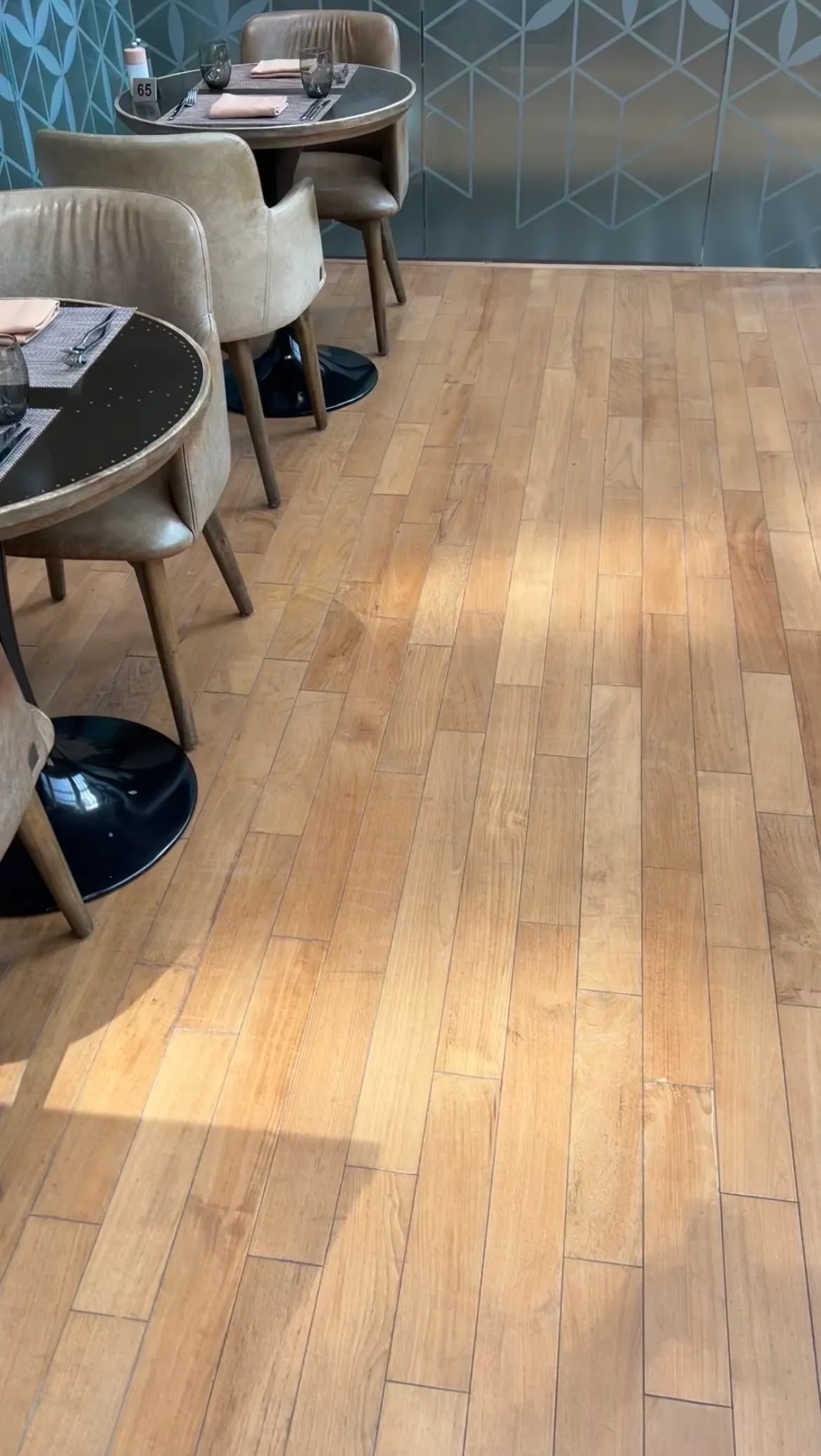 Restored timber plank flooring in a hospitality dining area